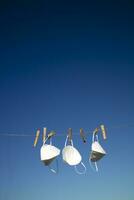 Coronavirus protection masks hung out to dry photo