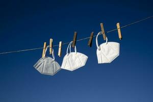 Coronavirus protection masks hung out to dry photo