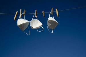 Coronavirus protection masks hung out to dry photo