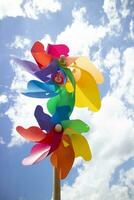 Multicolored pinwheels in the blue sky photo