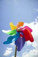 Multicolored pinwheels in the blue sky photo