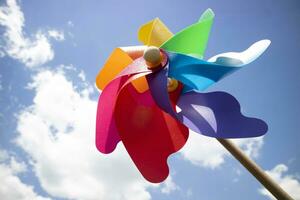 Multicolored pinwheels in the blue sky photo