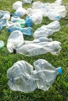 Used plastic bottles abandoned in a meadow photo