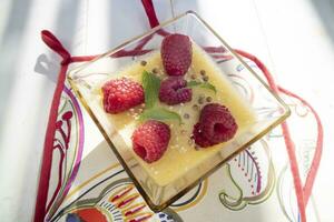 Vegan cooking creme caramel with raspberries photo