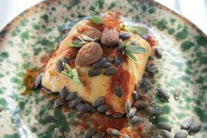 Vegan cooking creme caramel with pumpkin seeds almonds and paprika photo