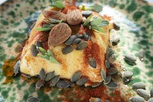 Vegan cooking creme caramel with pumpkin seeds almonds and paprika photo