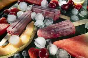 Popsicle made from red fruit on varied fruit table photo