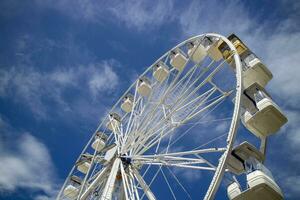 Ferris wheel of white color in blue sky photo