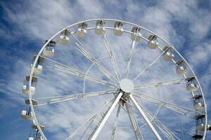 Ferris wheel of white color in blue sky photo