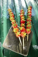 Skewer made with red and juicy Pachino tomatoes photo