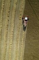 The work of a wheat harvester in the summer photo