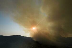 Large column of smoke from a forest fire photo