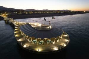 Aerial night view of the pier of Lido di Camaiore Tuscany Italy photo