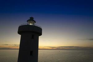 Aerial view of a maritime lighthouse taken at night photo