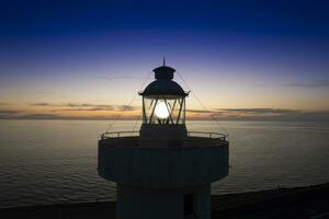 Aerial view of a maritime lighthouse taken at night photo