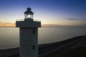 Aerial view of a maritime lighthouse taken at night photo