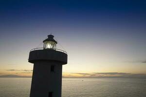 Aerial view of a maritime lighthouse taken at night photo