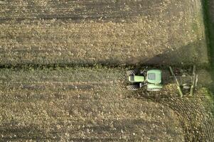 Aerial view of a tractor at the time of winter soil preparation photo