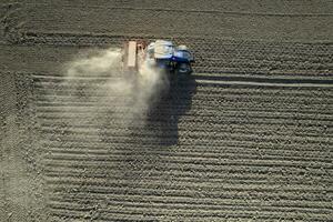 Aerial view of a tractor in the moment of sowing photo