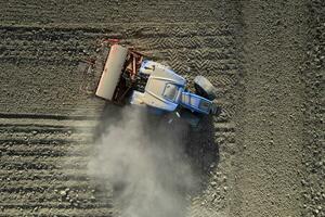 Aerial view of a tractor in the moment of sowing photo