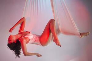 Beautiful young girl relaxing in a white colored hammock photo