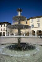 Public fountain in the square of Colle Val D'Elsa Tuscany Italy photo