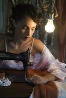 Young vintage girl intent on sewing by machine photo