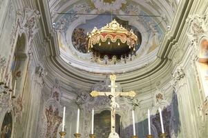 a church with a cross and a gold chandelier photo