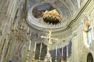 a church with a cross and a gold chandelier photo