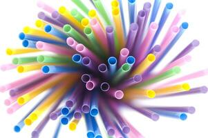 a bunch of colorful straws on a white background photo