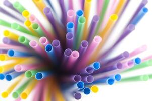 a bunch of colorful straws on a white background photo