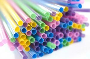 a bunch of colorful straws on a white background photo