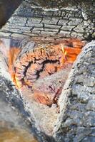 a close up of a fire burning in a wood photo