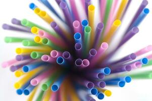 a bunch of colorful straws on a white background photo