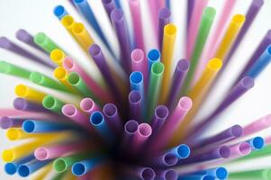 a bunch of colorful straws on a white background photo