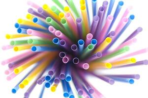 a bunch of colorful straws on a white background photo