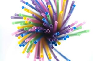 a bunch of colorful straws on a white background photo