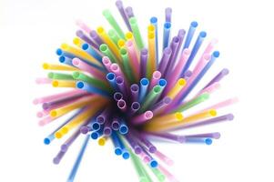 a bunch of colorful straws on a white background photo