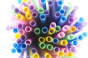 a bunch of colorful straws on a white background photo