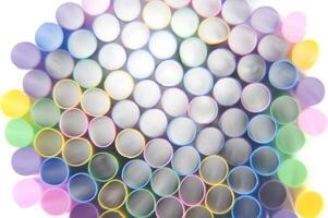 a bunch of colorful straws on a white background photo