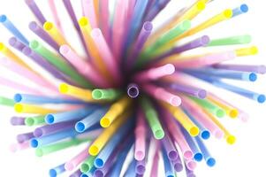 a bunch of colorful straws on a white background photo