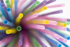 a bunch of colorful straws on a white background photo