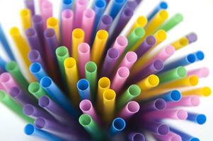 a bunch of colorful straws on a white background photo