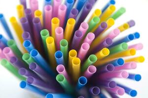 a bunch of colorful straws on a white background photo