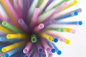 a bunch of colorful straws on a white background photo