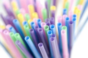 a bunch of colorful straws on a white background photo