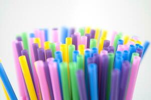 a bunch of colorful straws on a white background photo