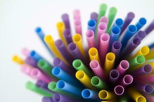 a bunch of colorful straws on a white background photo