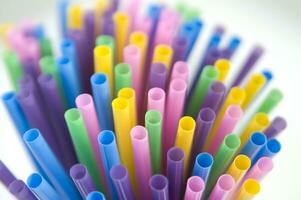 a bunch of colorful straws on a white background photo