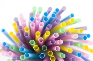 a bunch of colorful straws on a white background photo